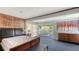 Spacious bedroom with a large bed, sliding glass doors to balcony, and wood accents at 8440 Midnight Pass Rd, Sarasota, FL 34242