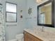 Bathroom with vanity, toilet, shower, and nautical decor at 9150 Melody Cir, Port Charlotte, FL 33981