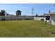 Large grassy backyard with privacy fence and grill at 9359 Casa Grande Ave, Englewood, FL 34224