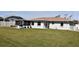 Spacious backyard with screened patio and lush lawn at 9359 Casa Grande Ave, Englewood, FL 34224