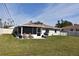 Large backyard with patio, grill, and lawn at 9359 Casa Grande Ave, Englewood, FL 34224