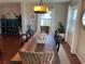 Spacious dining area featuring a rustic farmhouse table and wicker chairs at 9359 Casa Grande Ave, Englewood, FL 34224