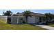 Single story home with white garage door and fenced yard at 9359 Casa Grande Ave, Englewood, FL 34224