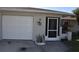 Front view of single story home with white garage door at 9359 Casa Grande Ave, Englewood, FL 34224