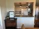 Modern kitchen with a breakfast bar and view to the dining room at 9359 Casa Grande Ave, Englewood, FL 34224