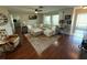 Spacious living room featuring hardwood floors, L-shaped sectional sofa, and a fireplace at 9359 Casa Grande Ave, Englewood, FL 34224