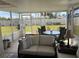 Spacious screened porch with outdoor seating and backyard access at 9359 Casa Grande Ave, Englewood, FL 34224