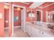 Bathroom with double vanity and coral-colored walls at 1005 Ibis Ct, Bradenton, FL 34209