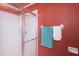 Bathroom with shower stall, towels, and red walls at 1005 Ibis Ct, Bradenton, FL 34209