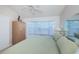 Primary bedroom with a king bed and large window at 1005 Ibis Ct, Bradenton, FL 34209