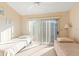 Bright bedroom with two twin beds and sliding glass doors at 1005 Ibis Ct, Bradenton, FL 34209