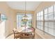Bright breakfast nook with a round table and view to backyard at 1005 Ibis Ct, Bradenton, FL 34209