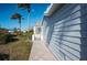 Side view of home with walkway, gate, and landscaping at 1005 Ibis Ct, Bradenton, FL 34209