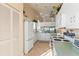 White kitchen with light green countertops and breakfast nook at 1005 Ibis Ct, Bradenton, FL 34209