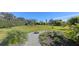 Landscaped backyard with a gravel pathway and lush tropical plants at 10656 Glencorse Ter, Bradenton, FL 34211
