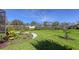 Landscaped backyard with lush lawn and tropical plants at 10656 Glencorse Ter, Bradenton, FL 34211