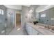 Elegant bathroom with double vanity and walk-in shower at 10656 Glencorse Ter, Bradenton, FL 34211