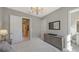 Spacious bedroom with a dresser, TV, and access to a bathroom at 10656 Glencorse Ter, Bradenton, FL 34211