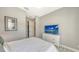 Serene bedroom with TV and plenty of natural light at 10656 Glencorse Ter, Bradenton, FL 34211