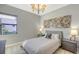 Guest bedroom with a queen bed, artwork, and dresser at 10656 Glencorse Ter, Bradenton, FL 34211