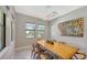 Elegant dining room with a live-edge wood table and large windows at 10656 Glencorse Ter, Bradenton, FL 34211