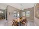 Bright dining area with live-edge wood table and modern light fixture at 10656 Glencorse Ter, Bradenton, FL 34211