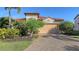 Single-story home with tile roof, attached garage, and lush landscaping at 10656 Glencorse Ter, Bradenton, FL 34211