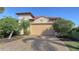 House exterior featuring a two-car garage and manicured landscaping at 10656 Glencorse Ter, Bradenton, FL 34211