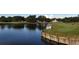 Aerial view of a lush golf course with a water feature and clubhouse in the background at 10656 Glencorse Ter, Bradenton, FL 34211