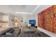Open concept living room with sectional sofa and large artwork at 10656 Glencorse Ter, Bradenton, FL 34211