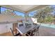 Outdoor kitchen with stainless steel appliances and dining area at 10656 Glencorse Ter, Bradenton, FL 34211