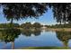 Serene pond with a wooden bridge and lush trees at 10656 Glencorse Ter, Bradenton, FL 34211