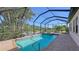 Screened pool and spa with brick pavers and tropical landscaping at 10656 Glencorse Ter, Bradenton, FL 34211