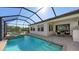 Inviting pool area with spa, covered patio, outdoor kitchen, and dining space at 10656 Glencorse Ter, Bradenton, FL 34211