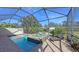 Screened-in pool and spa with lounge chair at 10656 Glencorse Ter, Bradenton, FL 34211