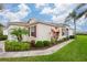 House with a well-maintained yard, walkway, and attractive landscaping at 1118 Radison Ave, Sun City Center, FL 33573