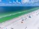 Drone view of beach with turquoise water and people at 112 Maple Ave, Anna Maria, FL 34216