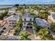 Two-story home with rooftop deck, near beach, and a paved driveway at 112 Maple Ave, Anna Maria, FL 34216