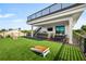 Backyard with deck, outdoor kitchen, and artificial turf at 112 Maple Ave, Anna Maria, FL 34216