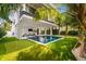 Inviting backyard oasis with pool, putting green, and lounge area at 112 Maple Ave, Anna Maria, FL 34216