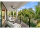 Relaxing balcony with outdoor seating and tropical views at 112 Maple Ave, Anna Maria, FL 34216