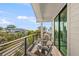 Private balcony with neighborhood views and seating at 112 Maple Ave, Anna Maria, FL 34216