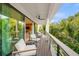 Relaxing balcony with outdoor seating and tropical views at 112 Maple Ave, Anna Maria, FL 34216