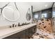 Modern bathroom with a double vanity and geometric tile shower at 112 Maple Ave, Anna Maria, FL 34216