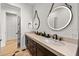 Double vanity bathroom with dark brown cabinets and a beige countertop at 112 Maple Ave, Anna Maria, FL 34216