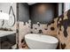 Modern bathroom featuring a freestanding tub and hexagon tile at 112 Maple Ave, Anna Maria, FL 34216