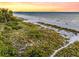 Aerial view of beach with people and dunes at sunset at 112 Maple Ave, Anna Maria, FL 34216