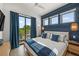Coastal-style bedroom with a king-size bed and private balcony at 112 Maple Ave, Anna Maria, FL 34216