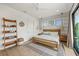 Light and airy bedroom with queen bed and sliding glass doors to balcony at 112 Maple Ave, Anna Maria, FL 34216