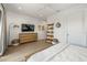 Spacious bedroom with dresser, shelving unit, and large TV at 112 Maple Ave, Anna Maria, FL 34216